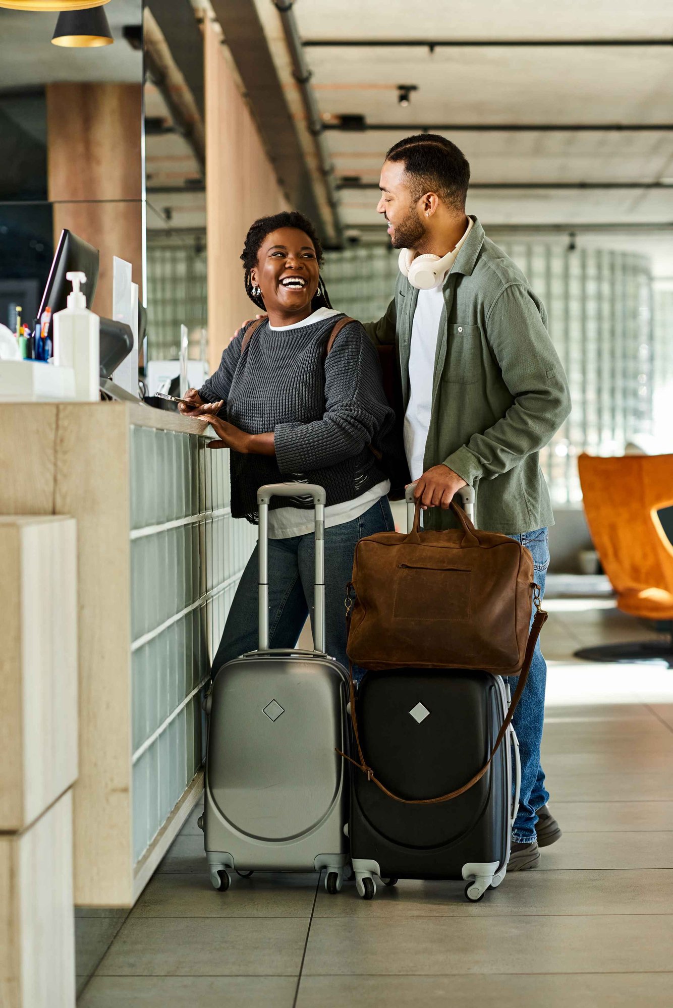 resized-a-joyful-young-couple-checks-into-a-hotel-lobby-fo-2024-12-27-06-28-57-utc