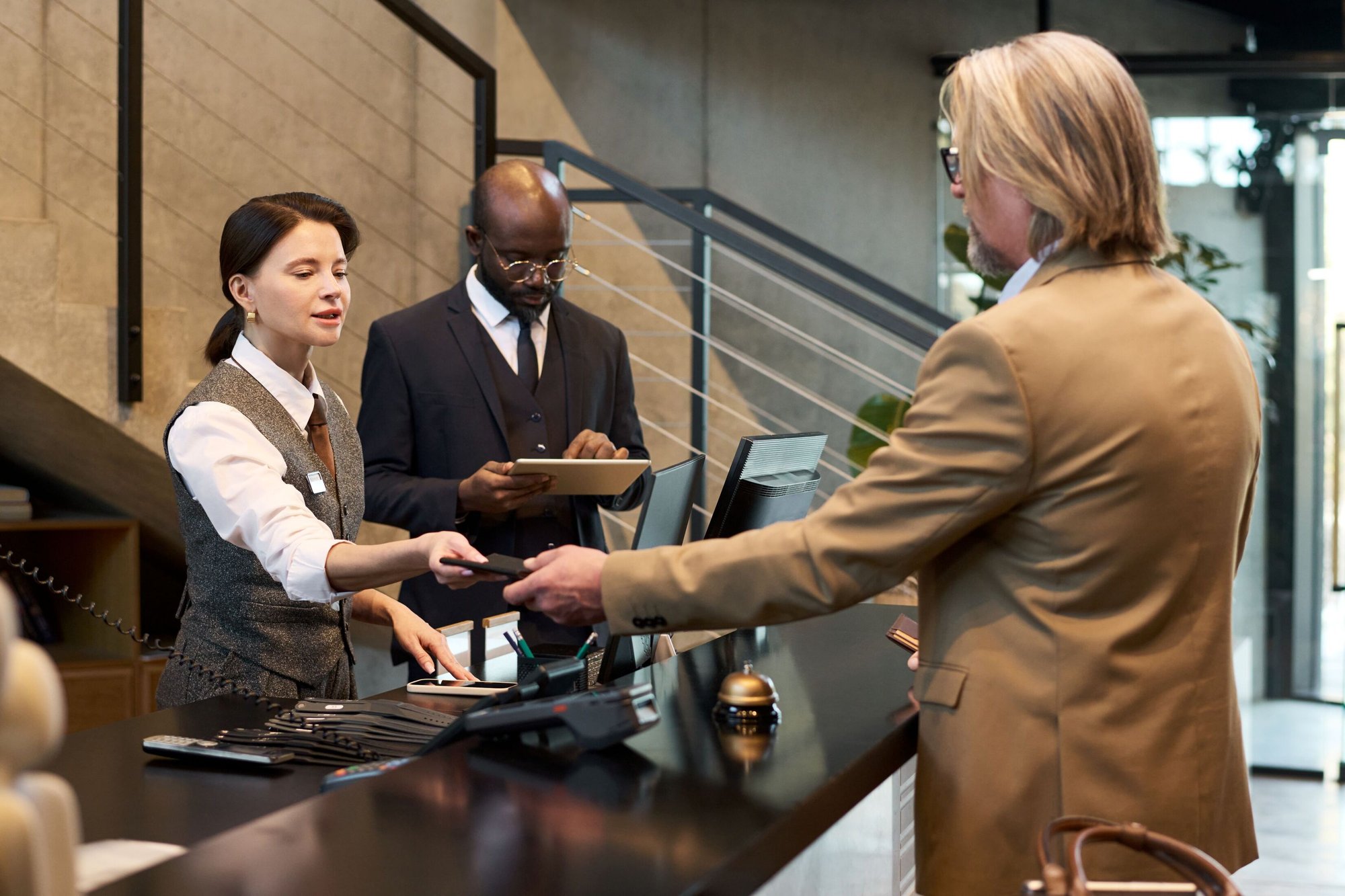 resized-conducting-business-at-hotel-reception-desk-2025-05-27-23-10-21-utc resized-conducting-business-at-hotel-reception-desk-2025-05-27-23-10-21-utc